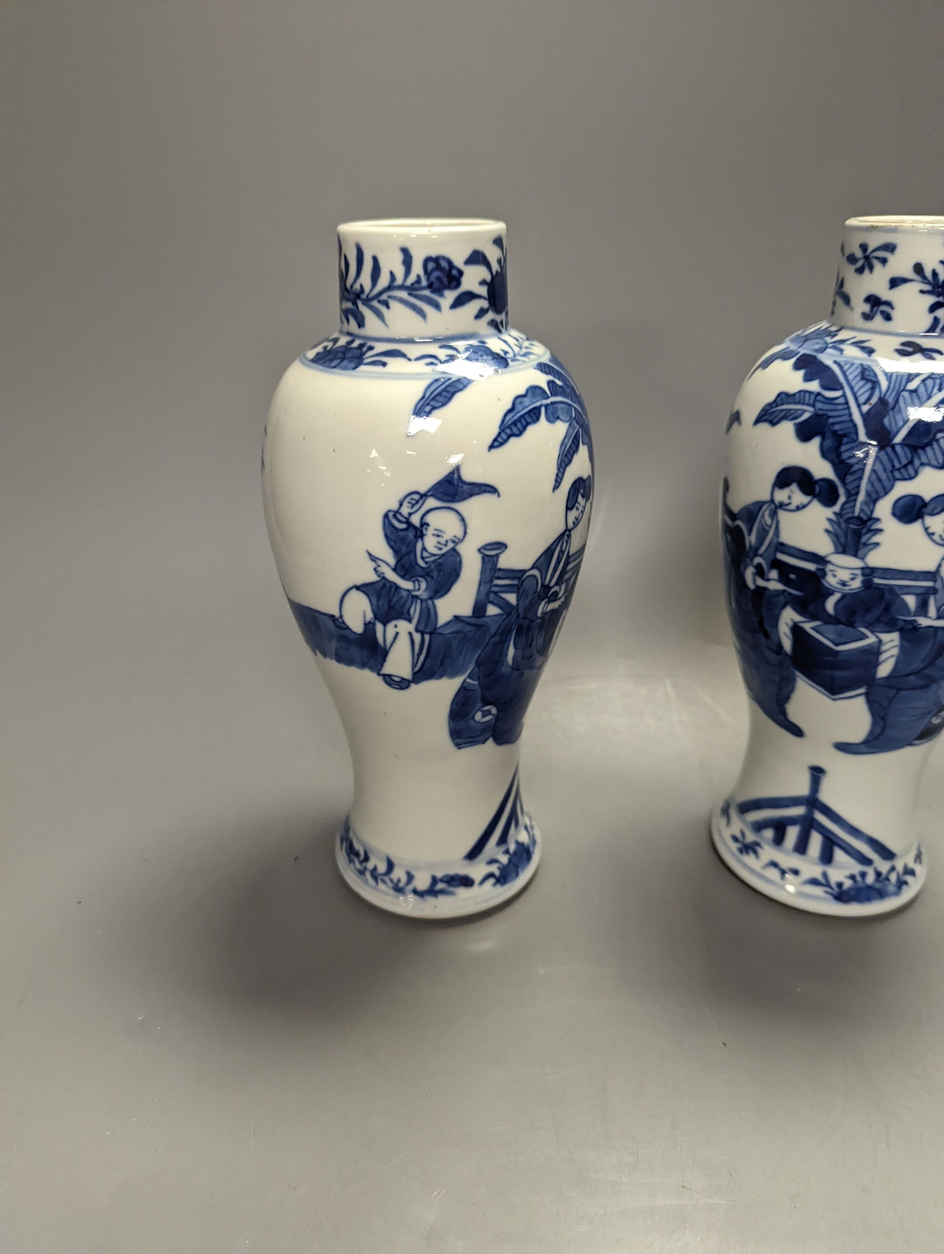 A pair of Chinese figural blue and white vases, drilled bases, height 25cm, and a plate